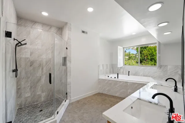 a bathroom with a bathtub and a shower