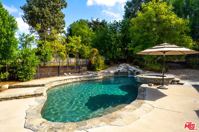 a view of a swimming pool with a patio