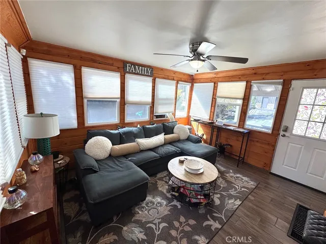 a living room with furniture a large window and a table