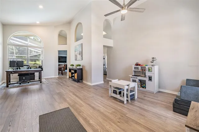 a living room with furniture and wooden floor