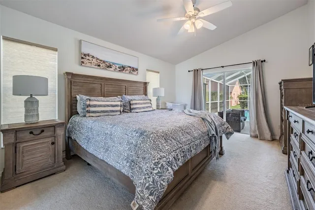 a bedroom with a bed a dresser and flat screen tv