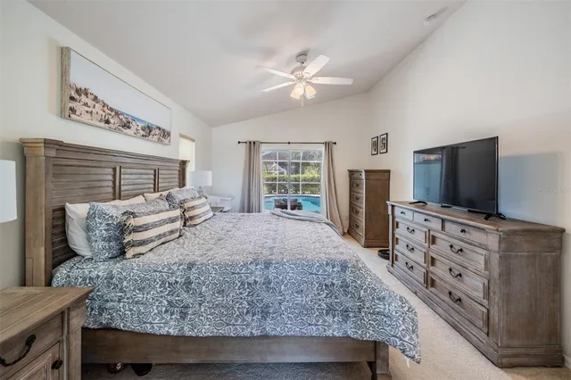 a bedroom with a large bed and a flat screen tv