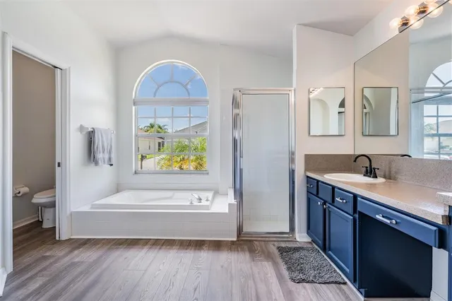 a bathroom with a tub sink and mirror