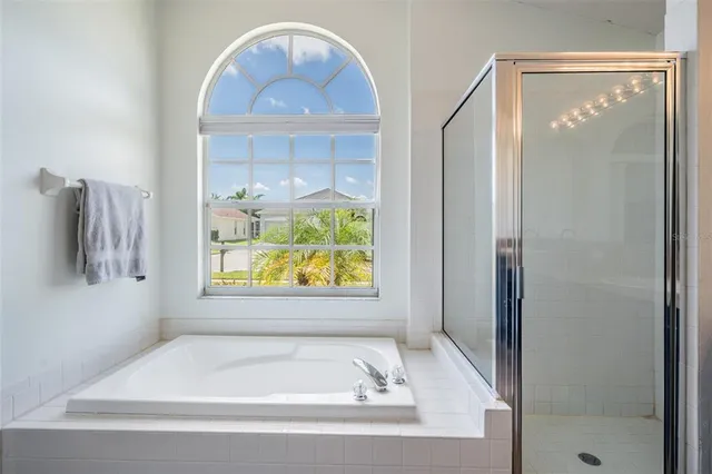 a bathroom with a tub and window