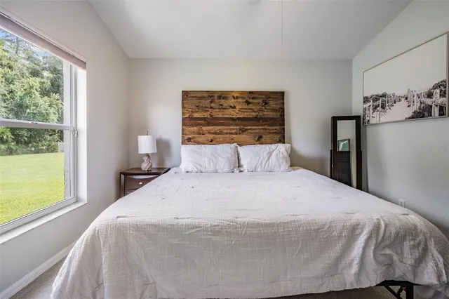 a bedroom with a bed and window