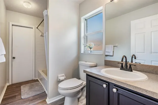 a bathroom with a sink toilet and vanity