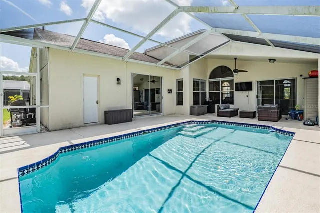 a view of a patio with dining table and chairs