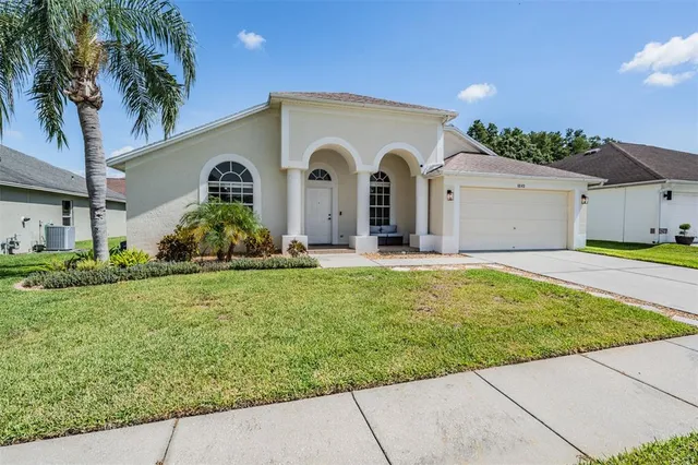 an aerial view of residential houses with outdoor space and swimming pool
