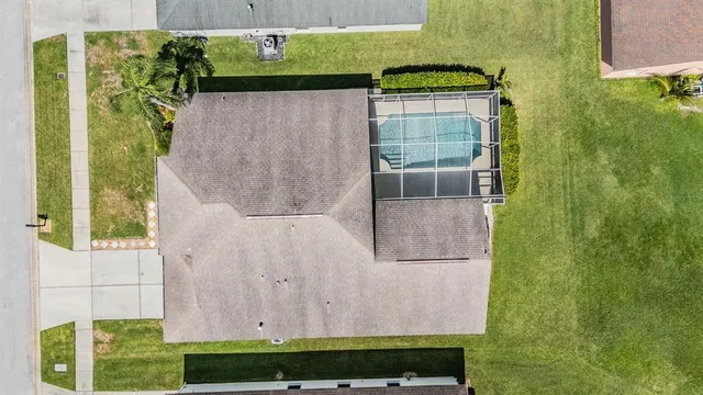 an aerial view of multiple houses with swimming pool and outdoor space