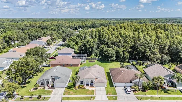 an aerial view of multiple houses with a yard