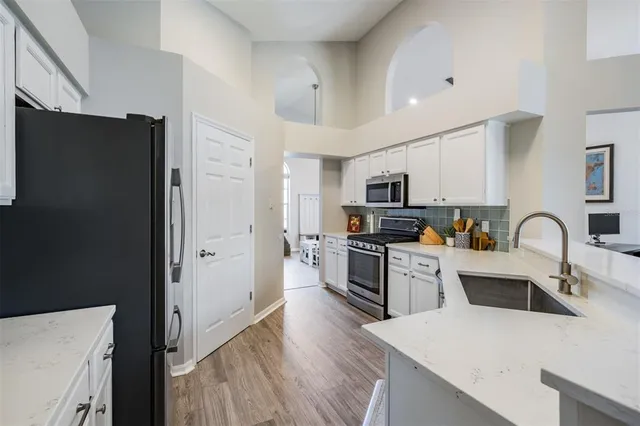 a kitchen with stainless steel appliances a refrigerator stove microwave and sink