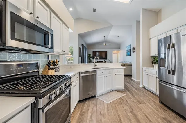 a kitchen with a stove a sink and a microwave