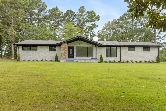 a front view of house with yard and green space