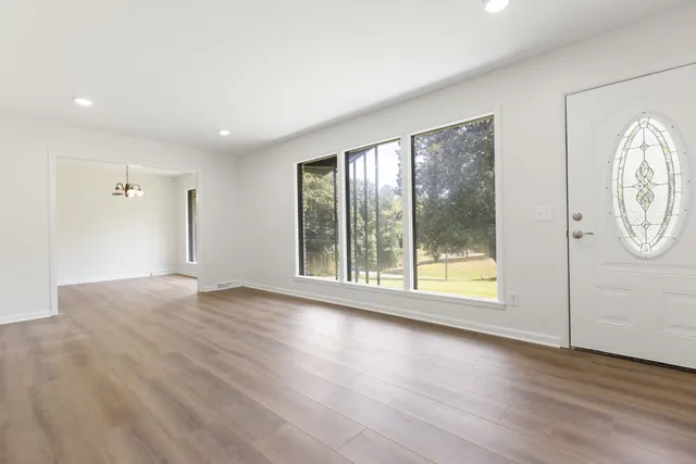a view of a room with wooden floor and window