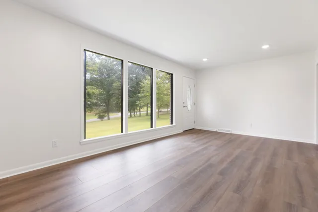 a kitchen with granite countertop white cabinets and stainless steel appliances