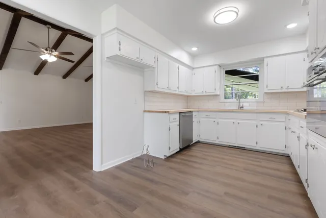 a view of empty room with wooden floor and fireplace