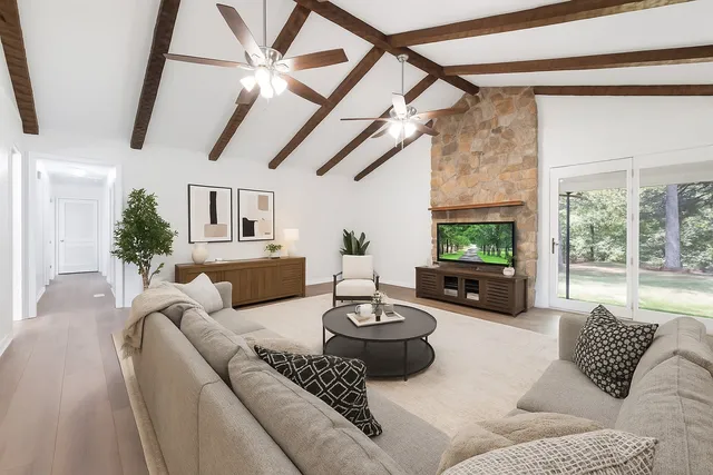 an empty room with wooden floor and ceiling fan