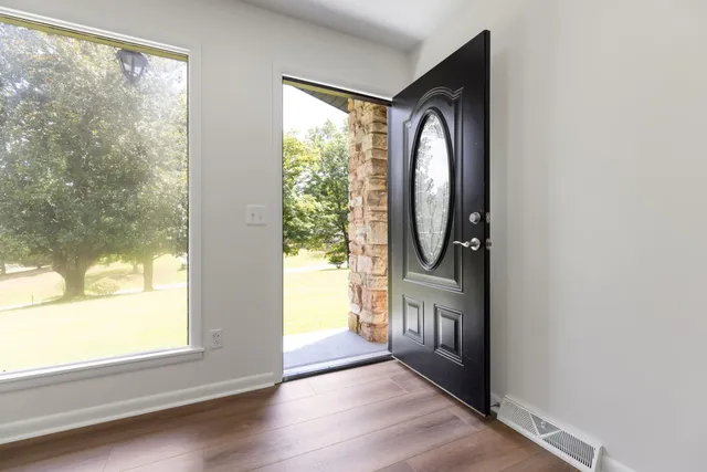 a view of an empty room and glass door