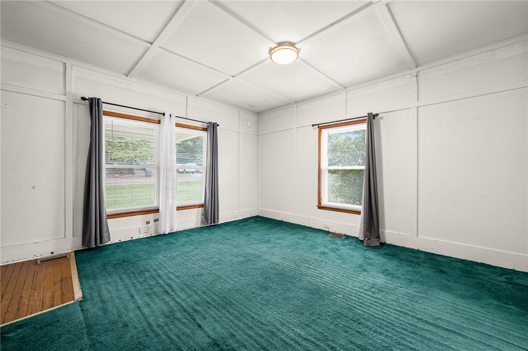 47 Square Street Pelzer, SC 29669 - Photo 11 of 29 Paneled walls and a grid-patterned ceiling define this versatile room with dual-aspect windows.