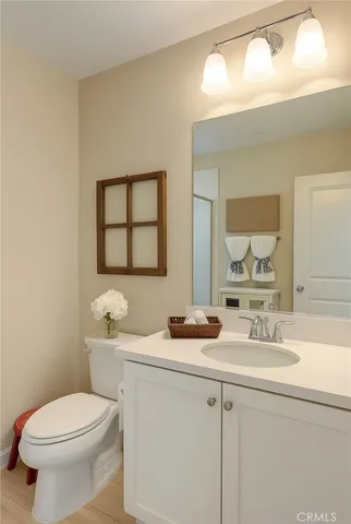 a bathroom with a toilet a sink and mirror