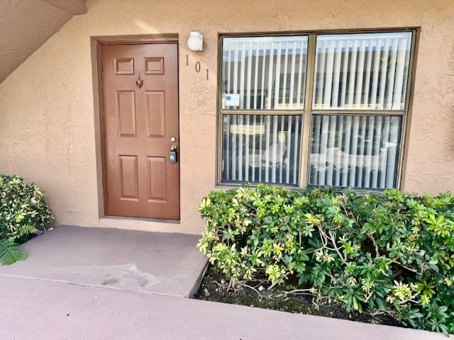 10006 Winding Lake Road, Unit 101 Sunrise, FL 33351 - Photo 14 of 14 a view of a porch with a bench