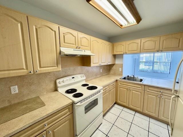 10006 Winding Lake Road, Unit 101 Sunrise, FL 33351 - Photo 2 of 14 a kitchen with stainless steel appliances granite countertop a sink a stove and white cabinets