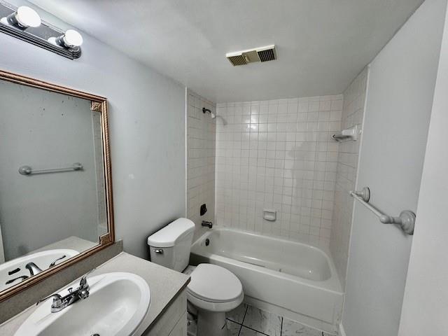 10006 Winding Lake Road, Unit 101 Sunrise, FL 33351 - Photo 9 of 14 a bathroom with a granite countertop bathtub shower sink vanity mirror and toilet