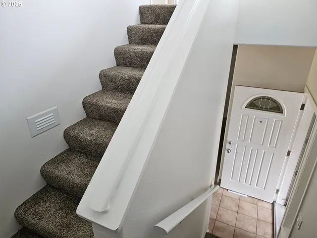a white couch sitting in a chair next to a blue wall