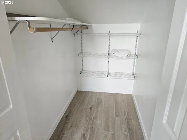 a view of a room with wooden floor