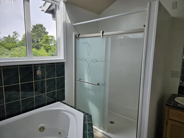 a bathroom with a tub and shower
