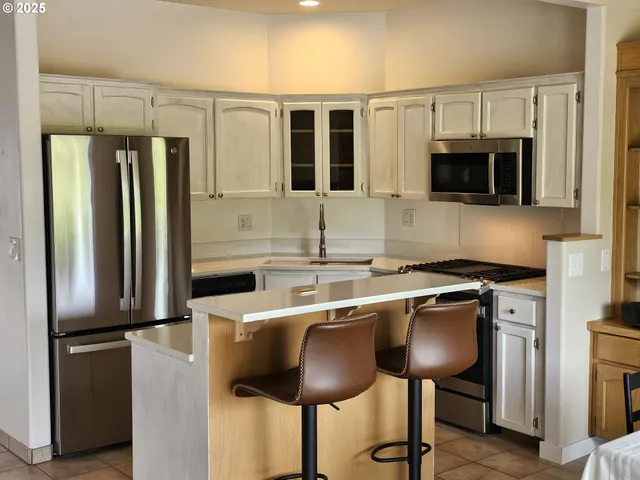 a kitchen with stainless steel appliances a sink and a refrigerator