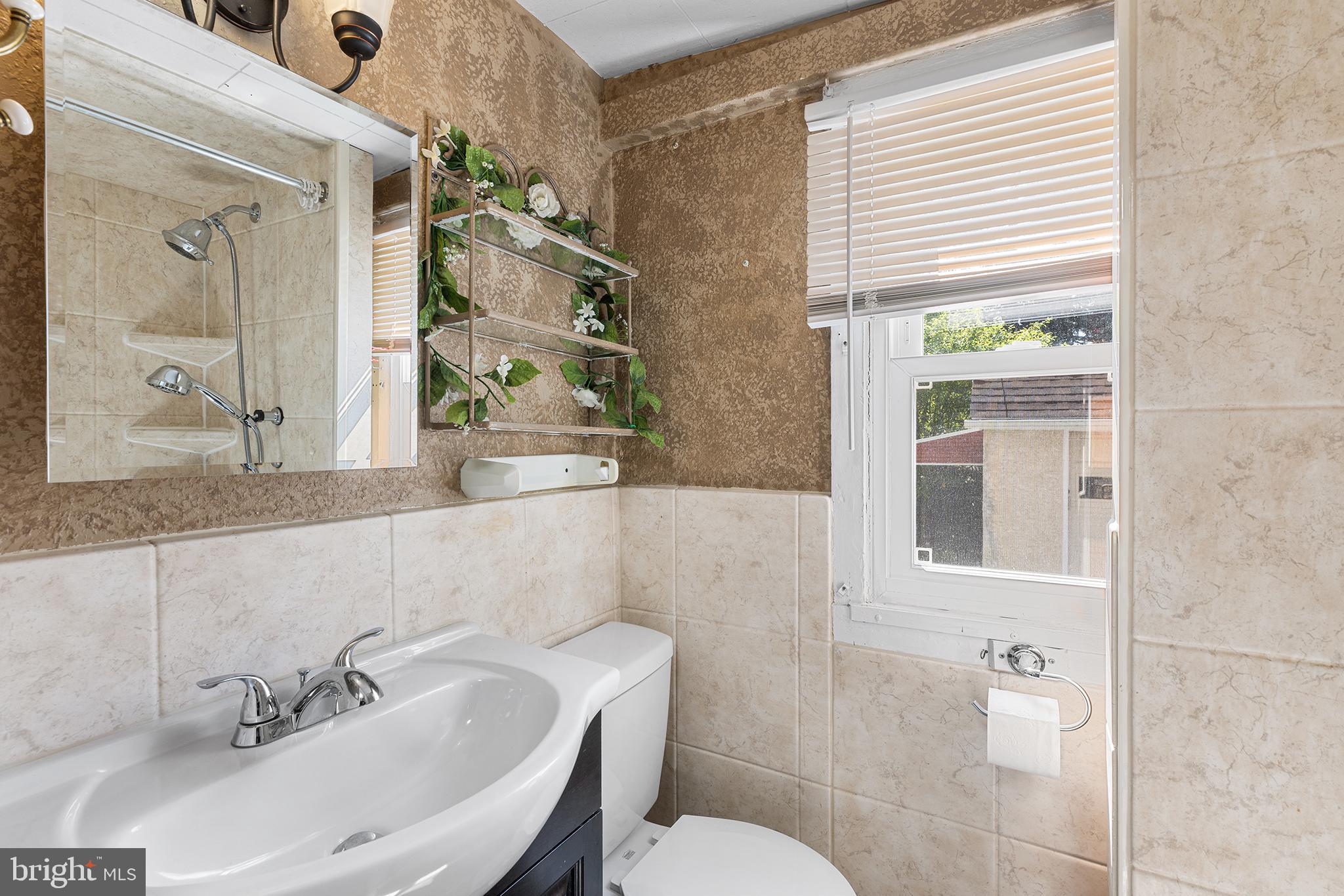 205 Callanan Avenue Bryn Mawr, PA 19010 - Photo 11 of 26 a bathroom with a sink and a mirror