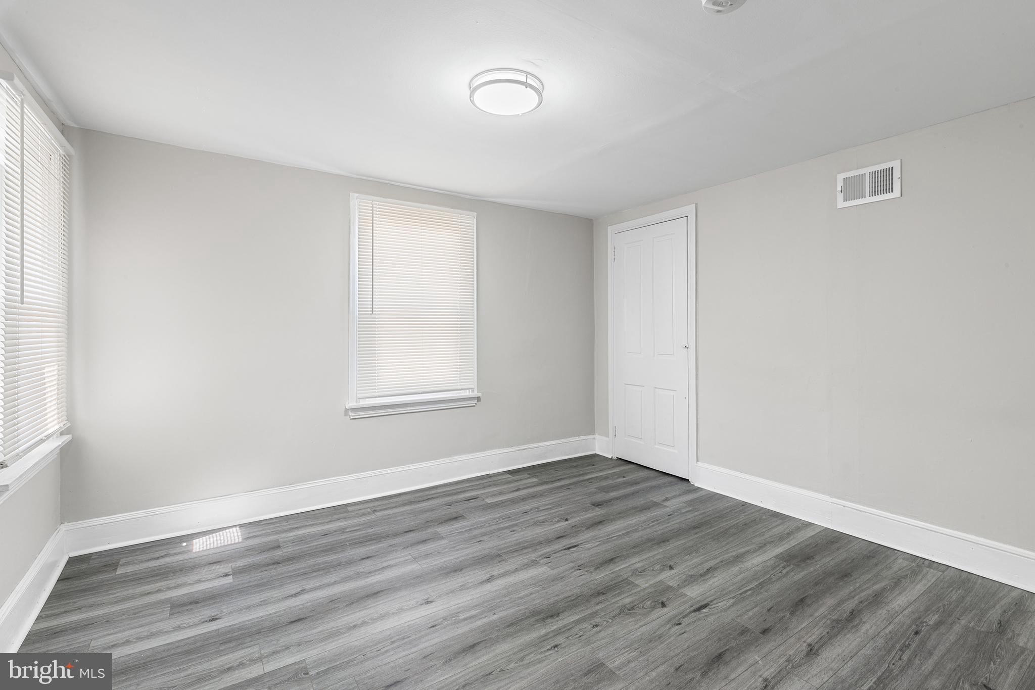 205 Callanan Avenue Bryn Mawr, PA 19010 - Photo 17 of 26 a view of an empty room with wooden floor and a window