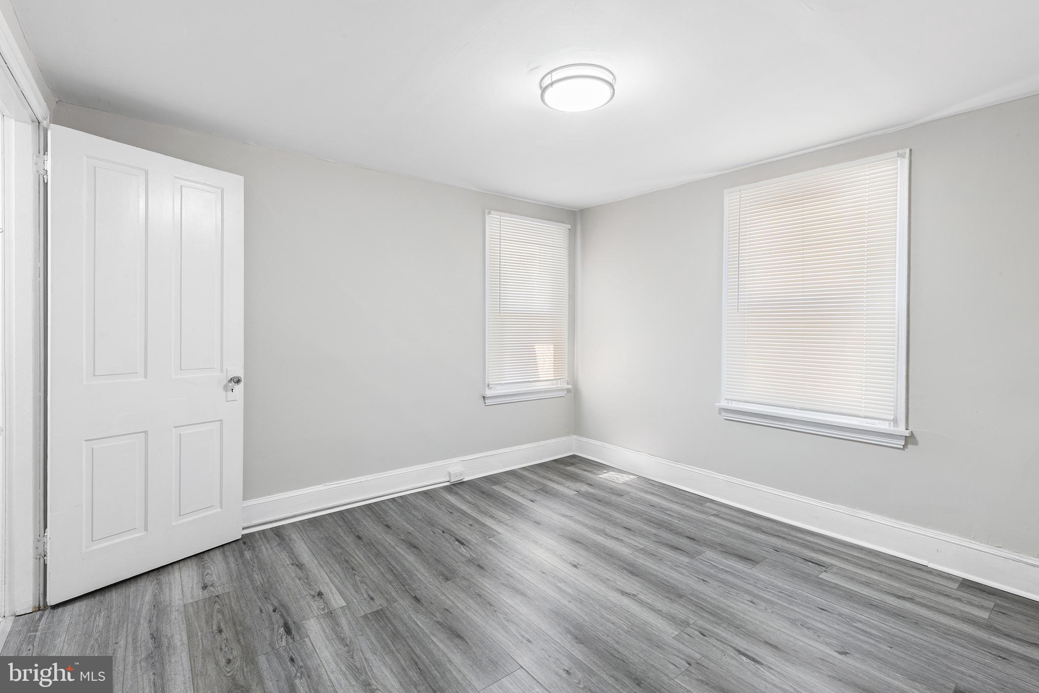 205 Callanan Avenue Bryn Mawr, PA 19010 - Photo 18 of 26 a view of an empty room with wooden floor and a window