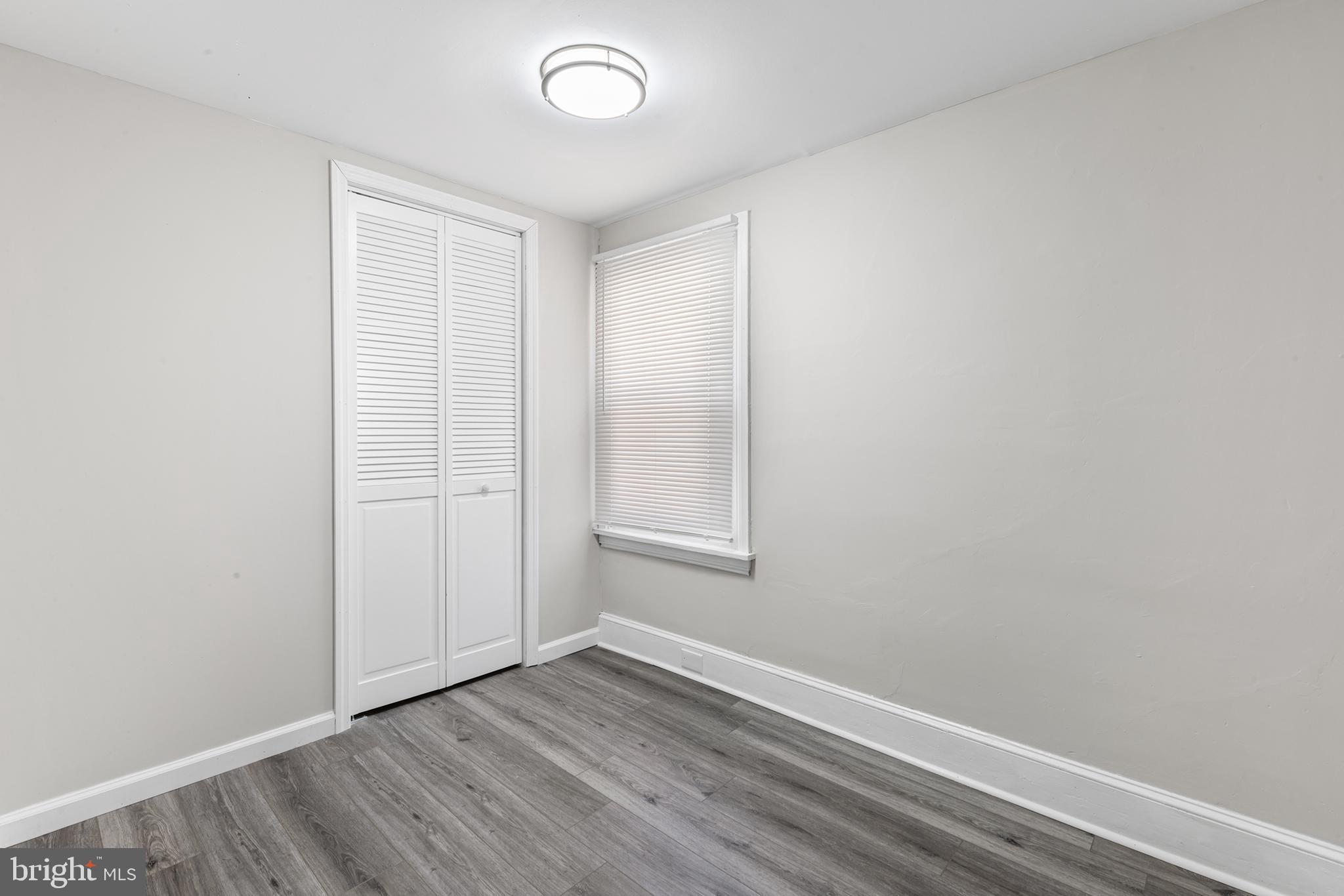 205 Callanan Avenue Bryn Mawr, PA 19010 - Photo 19 of 26 a view of an empty room with wooden floor and a window