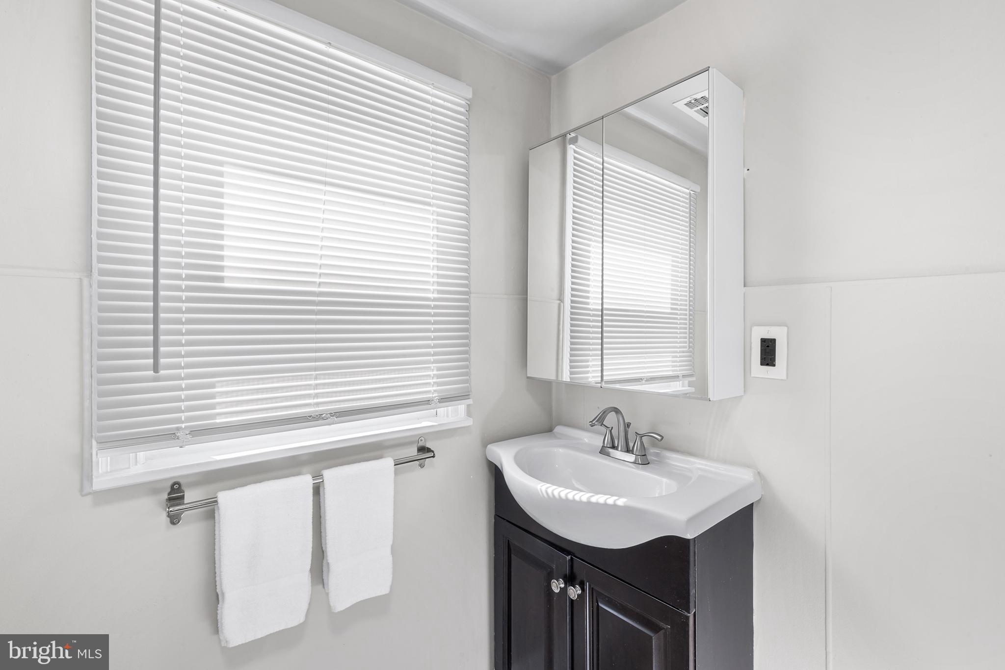 205 Callanan Avenue Bryn Mawr, PA 19010 - Photo 21 of 26 a bathroom with a sink and a mirror