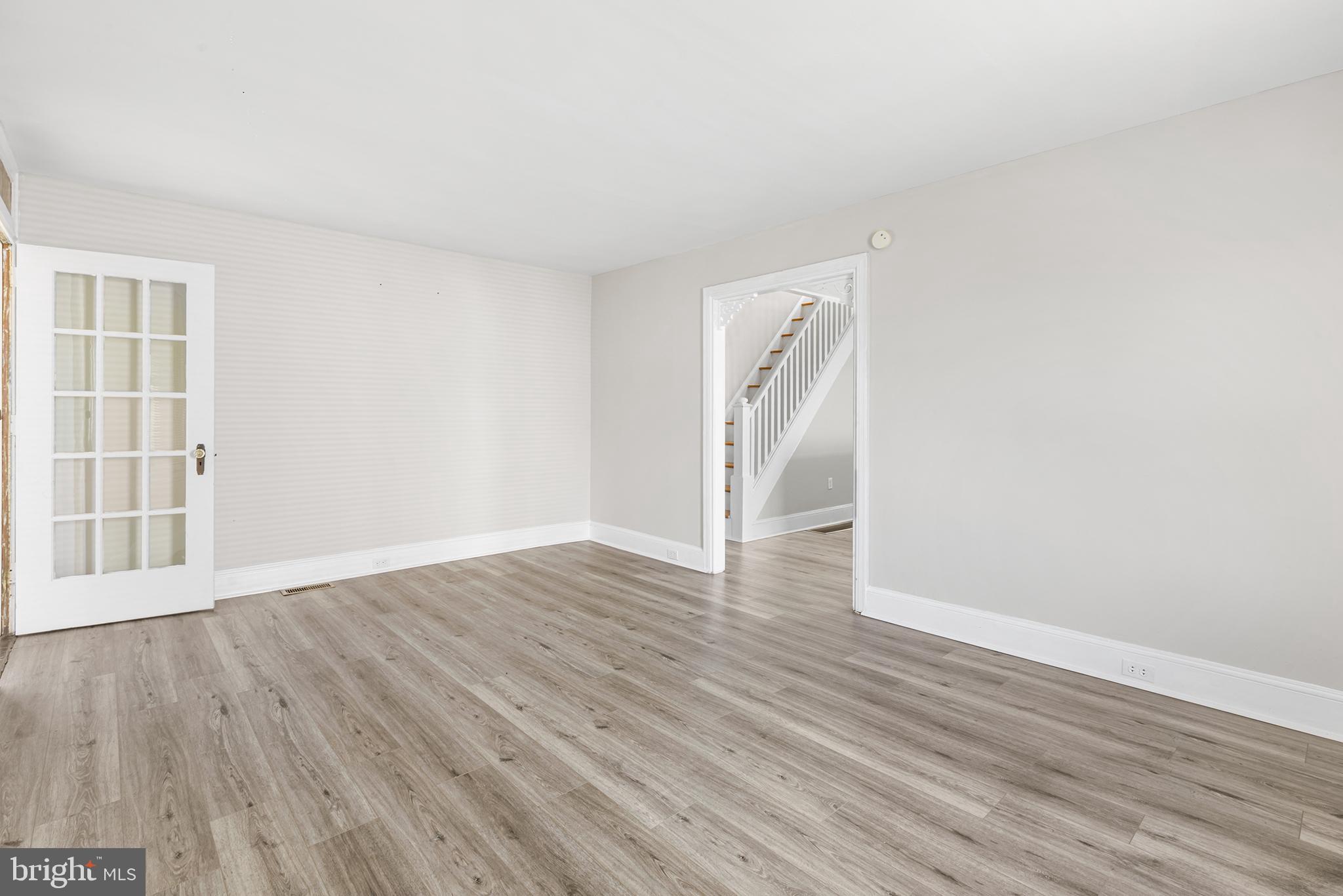 205 Callanan Avenue Bryn Mawr, PA 19010 - Photo 3 of 26 a view of an empty room with wooden floor and a window