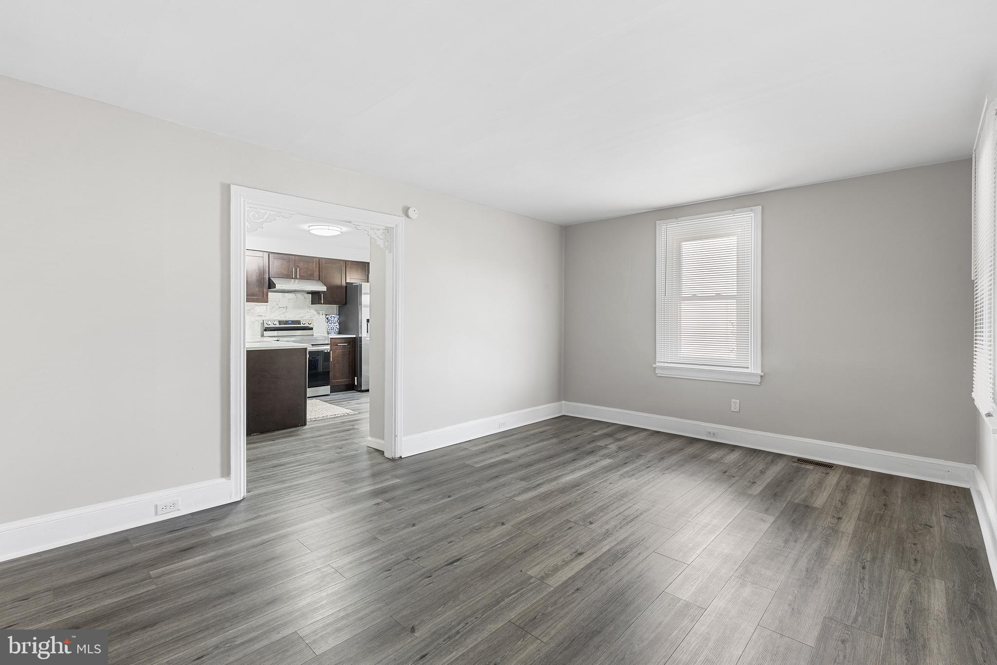 205 Callanan Avenue Bryn Mawr, PA 19010 - Photo 4 of 26 an empty room with wooden floor and a window