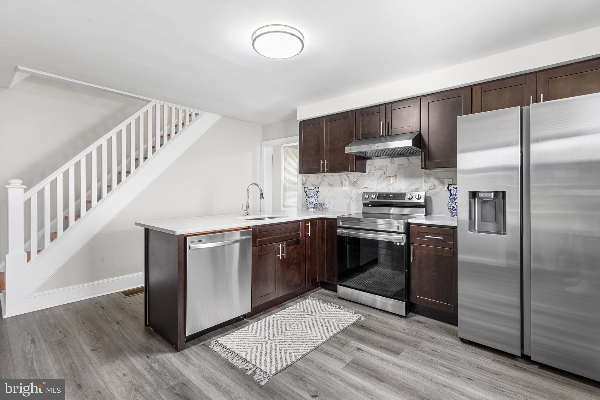 205 Callanan Avenue Bryn Mawr, PA 19010 - Photo 6 of 26 a kitchen with granite countertop a refrigerator and a stove top oven