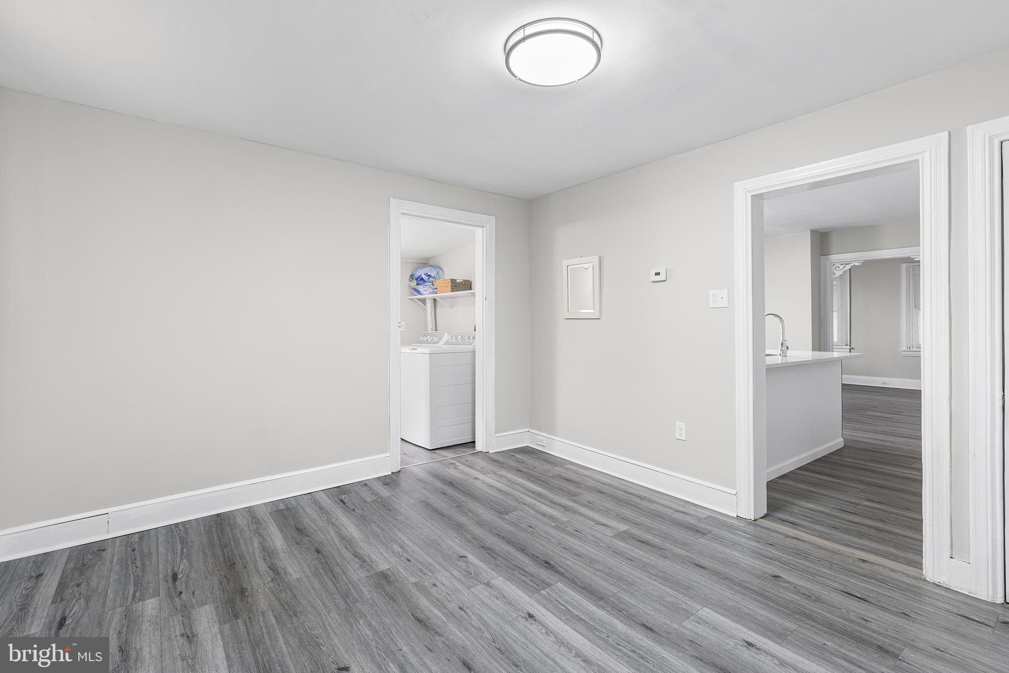 205 Callanan Avenue Bryn Mawr, PA 19010 - Photo 9 of 26 an empty room with wooden floor and windows