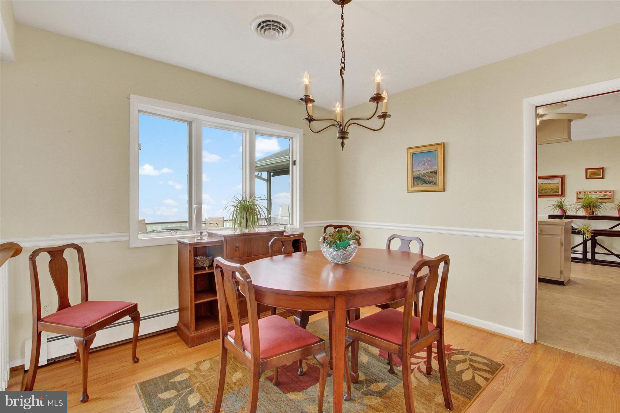 110 Lees Mill Road Hampstead, MD 21074 - Photo 11 of 39 a view of a dining room with furniture window and wooden floor