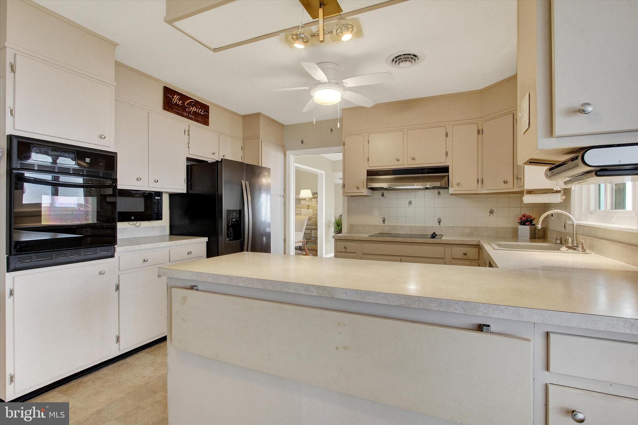 110 Lees Mill Road Hampstead, MD 21074 - Photo 14 of 39 a kitchen with granite countertop a sink stainless steel appliances and white cabinets