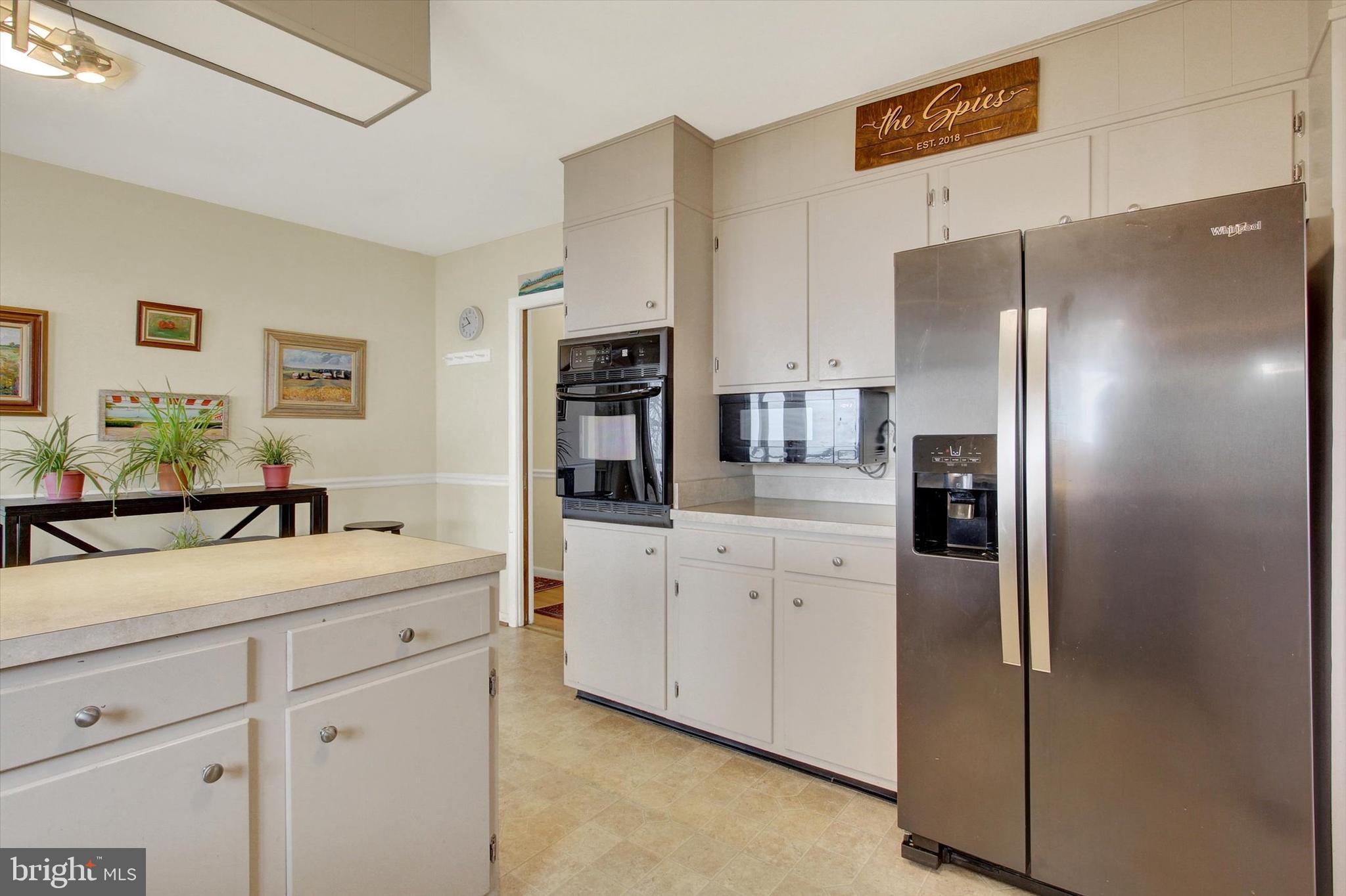 110 Lees Mill Road Hampstead, MD 21074 - Photo 15 of 39 a kitchen with stainless steel appliances a refrigerator sink and white cabinets