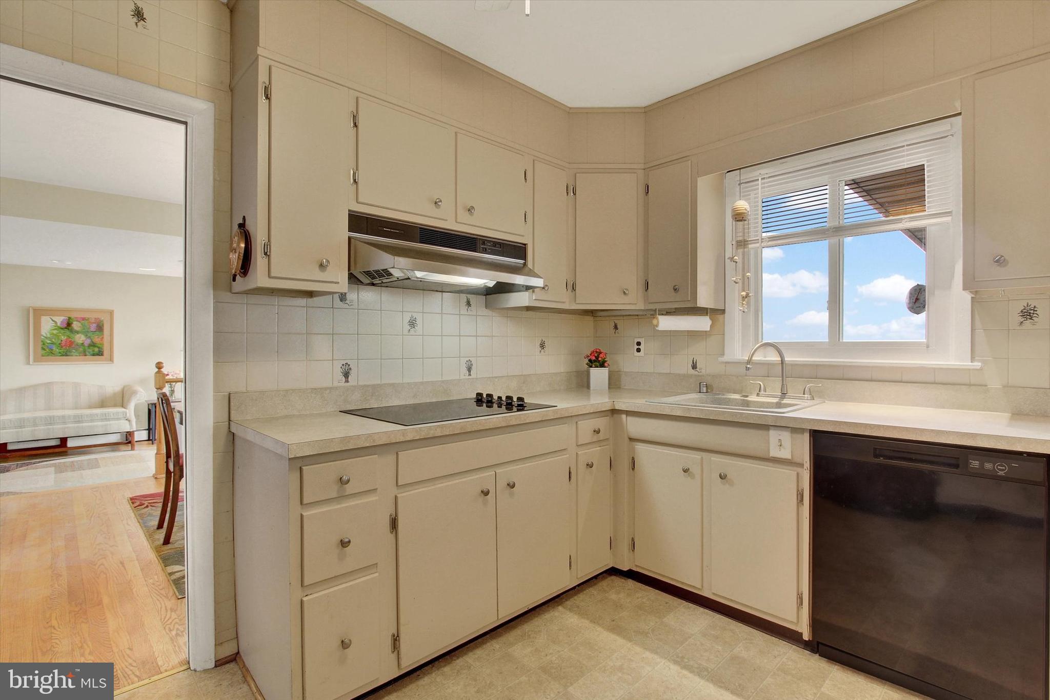 110 Lees Mill Road Hampstead, MD 21074 - Photo 17 of 39 a kitchen with a sink stove and cabinets