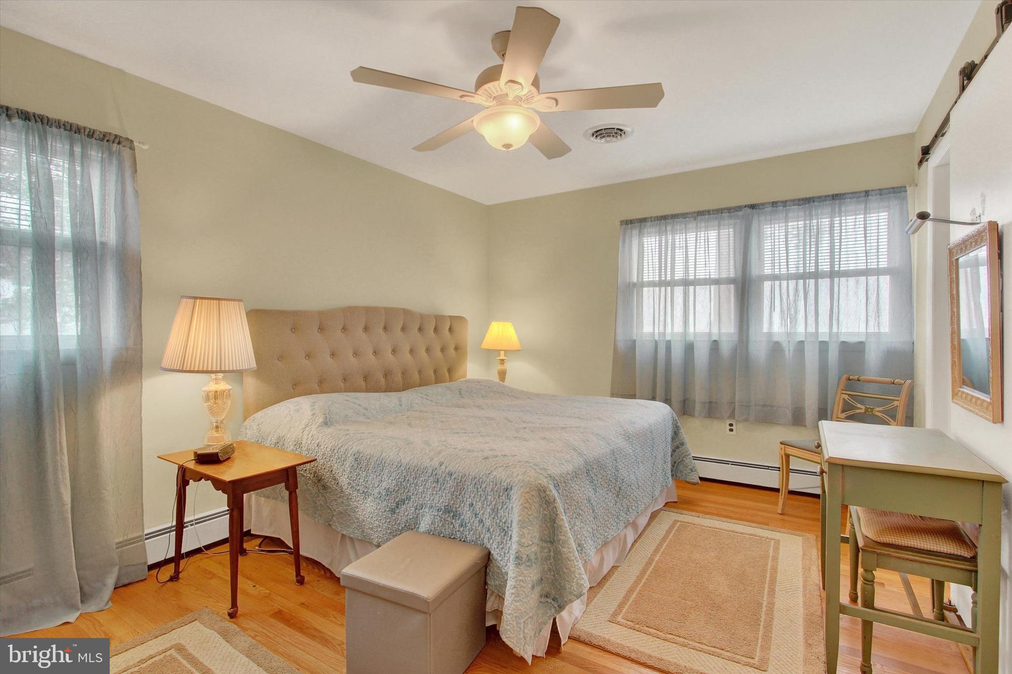 110 Lees Mill Road Hampstead, MD 21074 - Photo 19 of 39 a bedroom with a bed and a chandelier