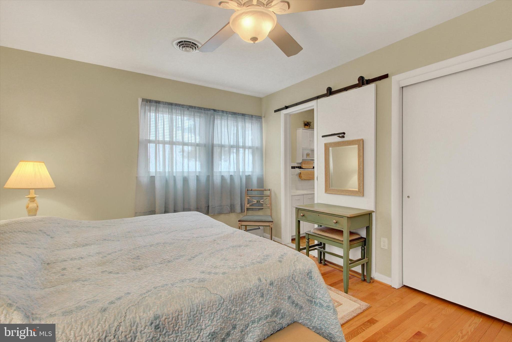 110 Lees Mill Road Hampstead, MD 21074 - Photo 20 of 39 a spacious bedroom with a bed and a chandelier