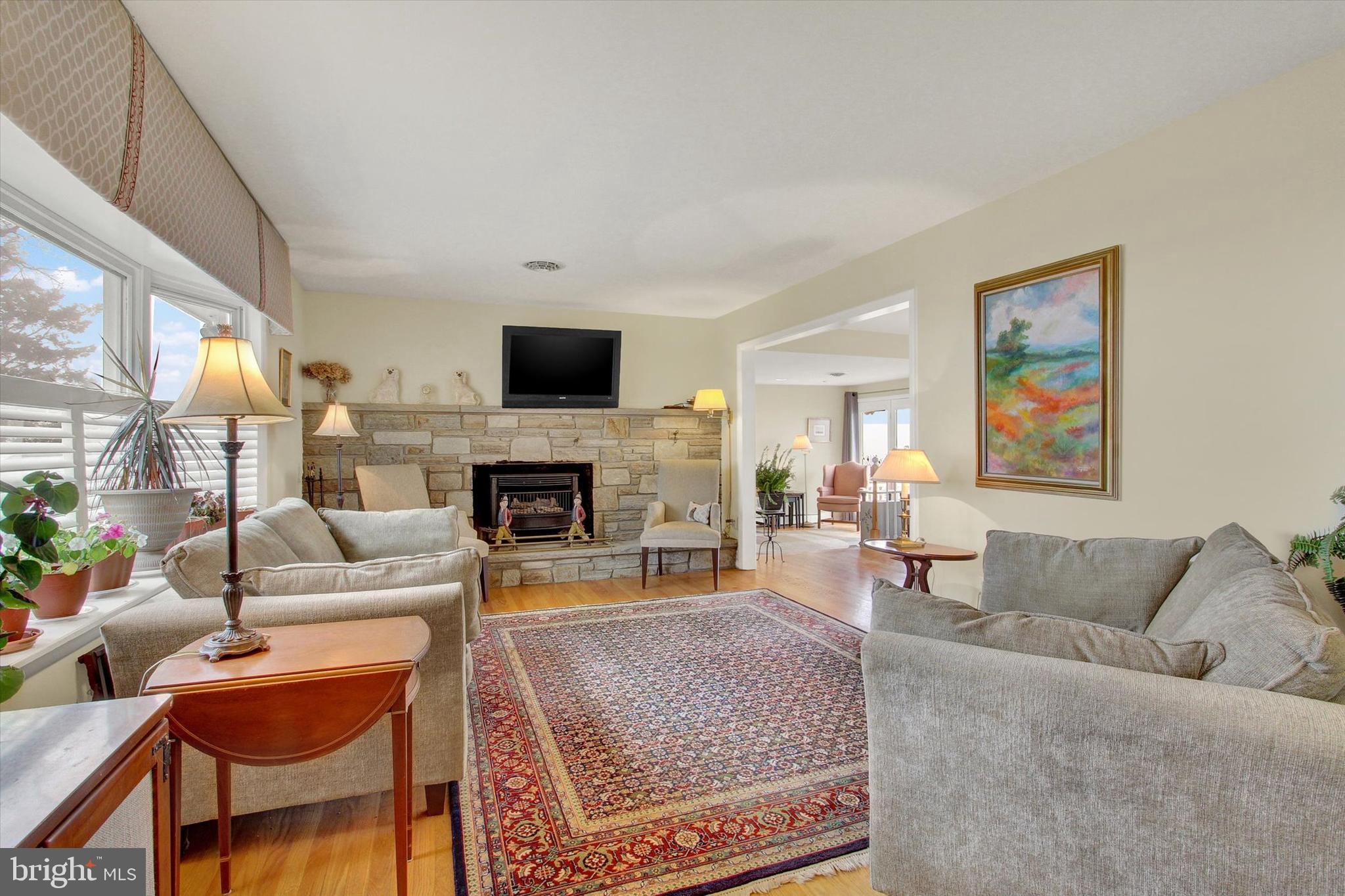110 Lees Mill Road Hampstead, MD 21074 - Photo 5 of 39 a living room with furniture a flat screen tv and a fireplace