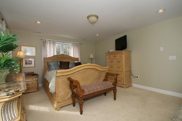 4 Devonshire Road Amesbury, MA 01913 - Photo 15 of 23 a bedroom with a bed and a flat screen tv