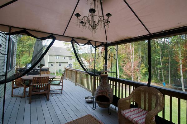 4 Devonshire Road Amesbury, MA 01913 - Photo 22 of 23 a view of a porch with furniture and wooden floor