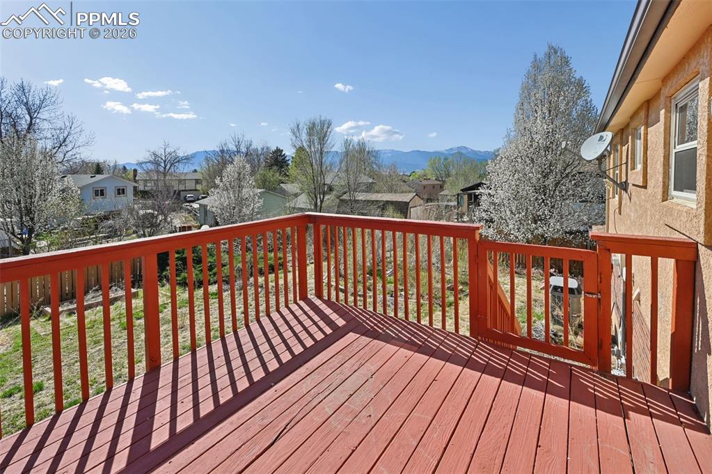 4963 Ridenour Drive Colorado Springs, CO 80916 - Photo 22 of 25 Deck with a residential view and a mountain view